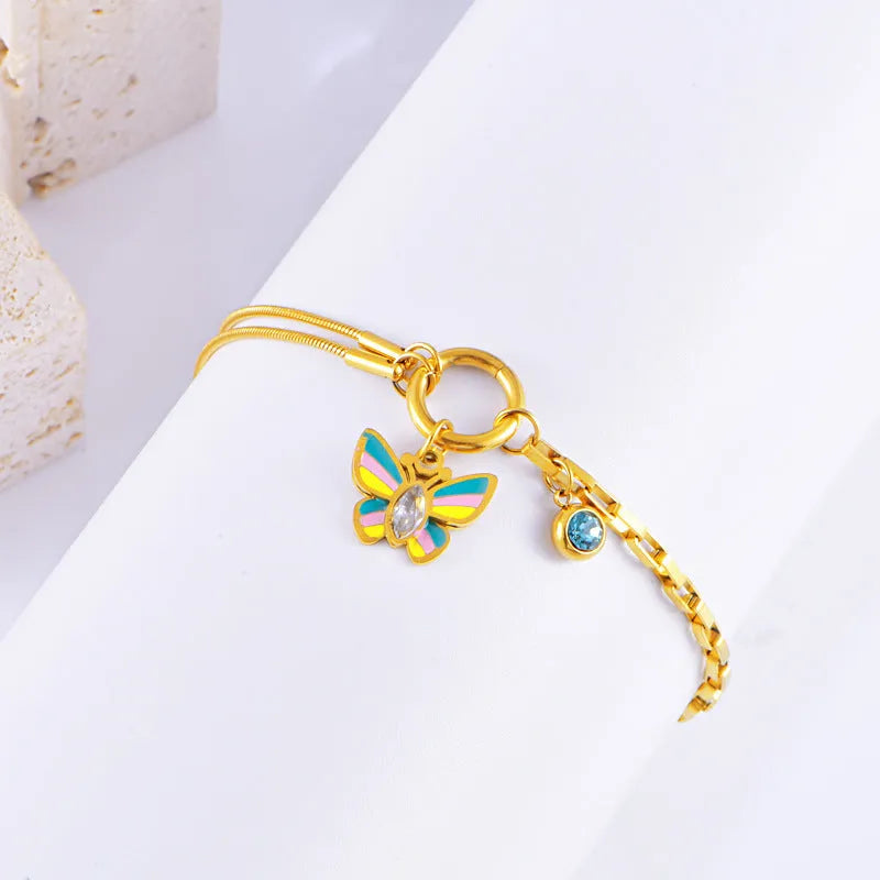 Gold titanium steel butterfly jewellery set with necklace and bracelet on snake bone chains