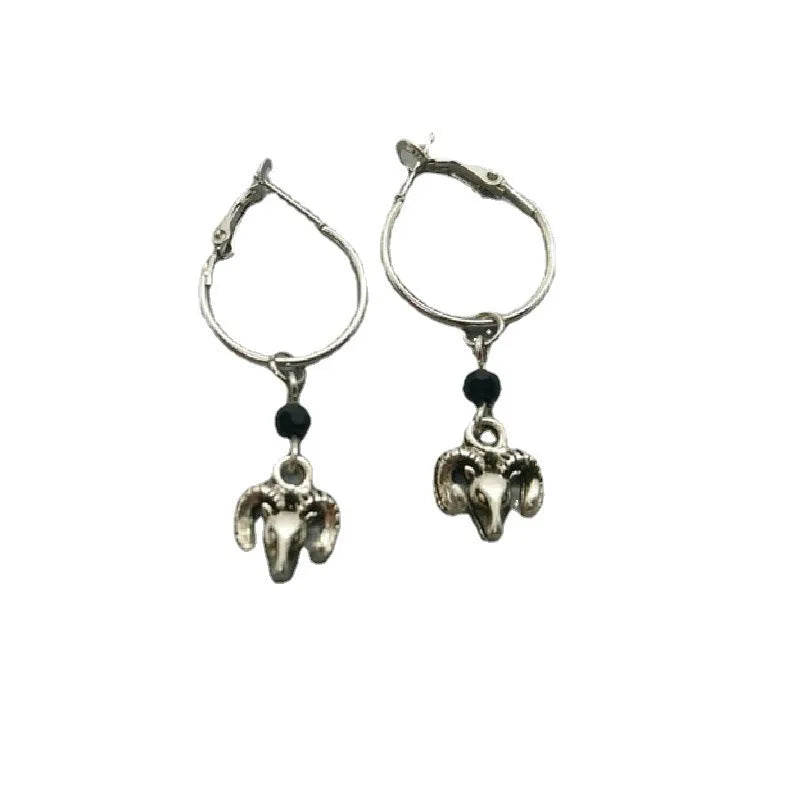 Silver-coloured round ring earrings for women featuring a raised Tibetan antelope design on an alloy metal hoop.
