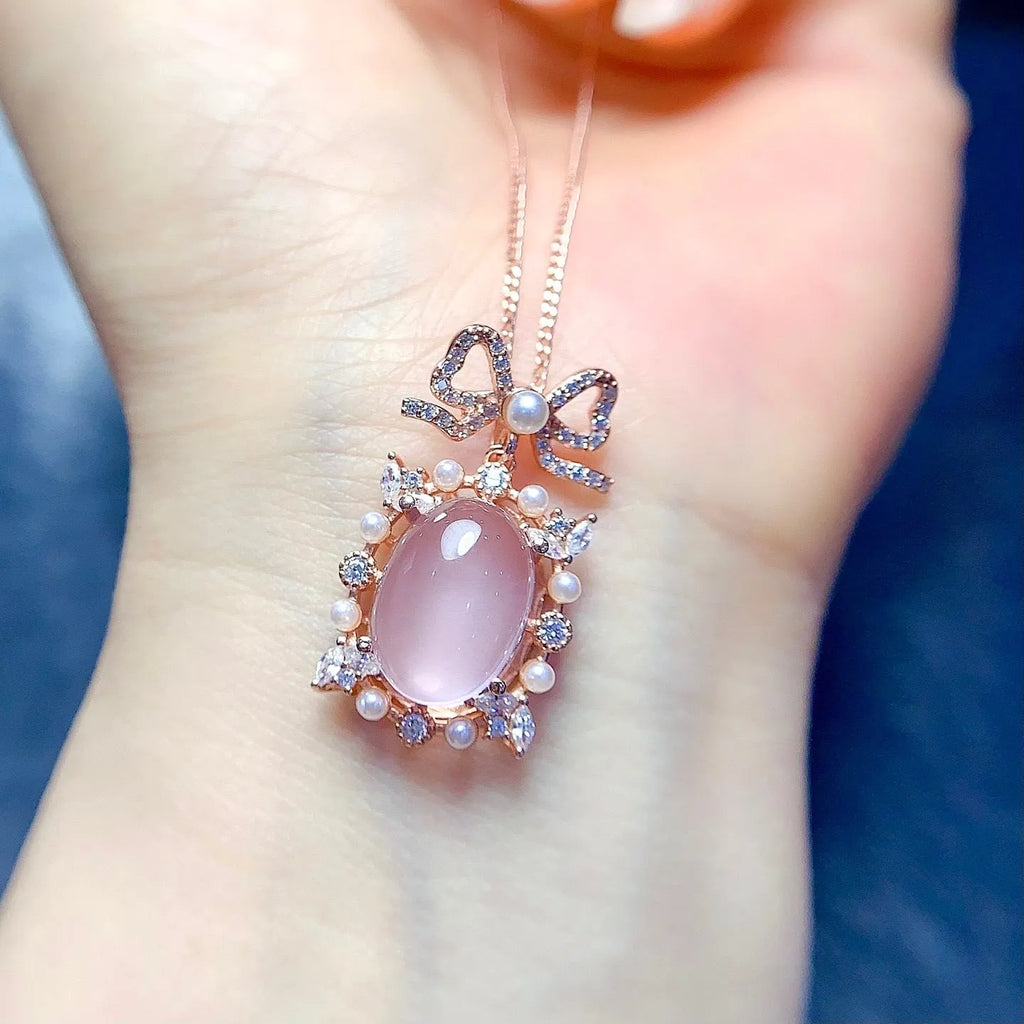 Geometric rose gold plated silver pendant with a natural pink rose quartz crystal on a chain.