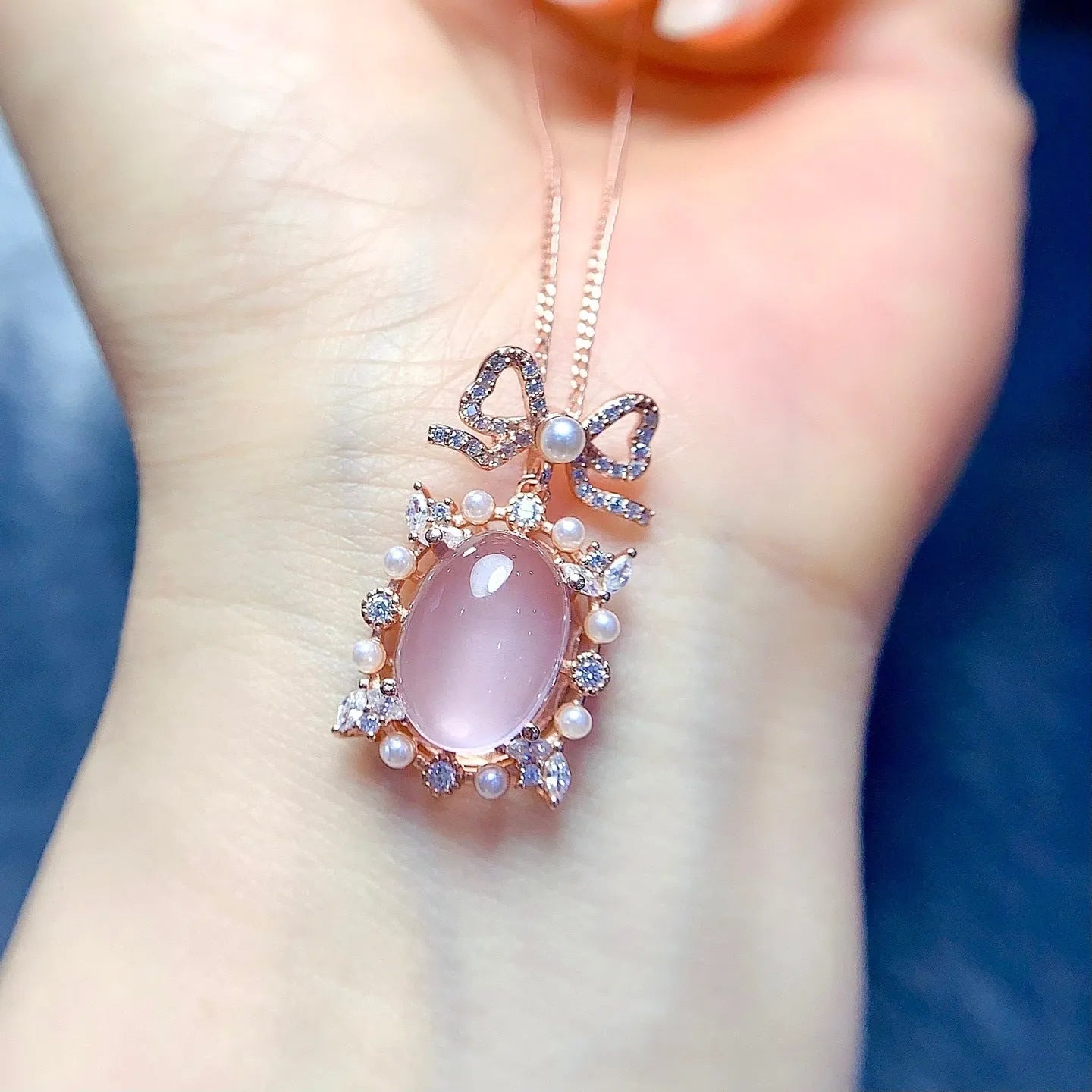 Geometric rose gold plated silver pendant with a natural pink rose quartz crystal on a chain.