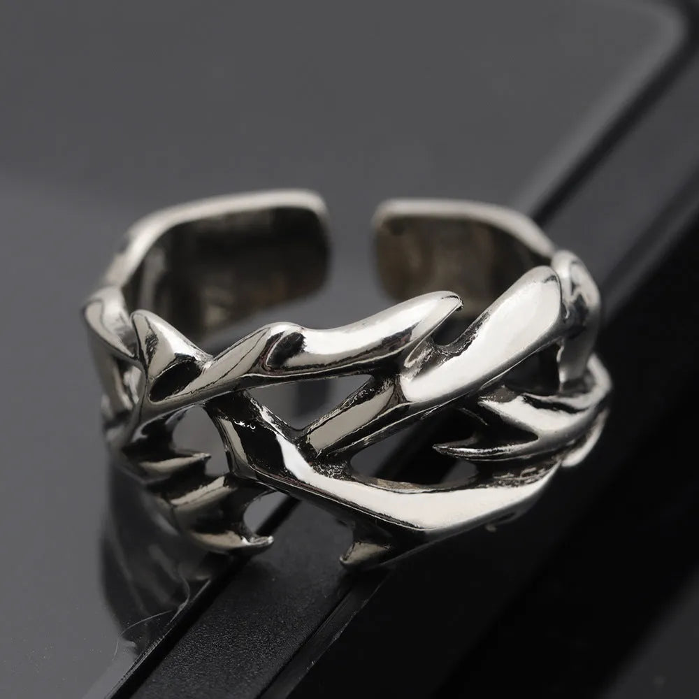Adjustable copper men's ring with geometric thorn and flower design showing opening mechanism