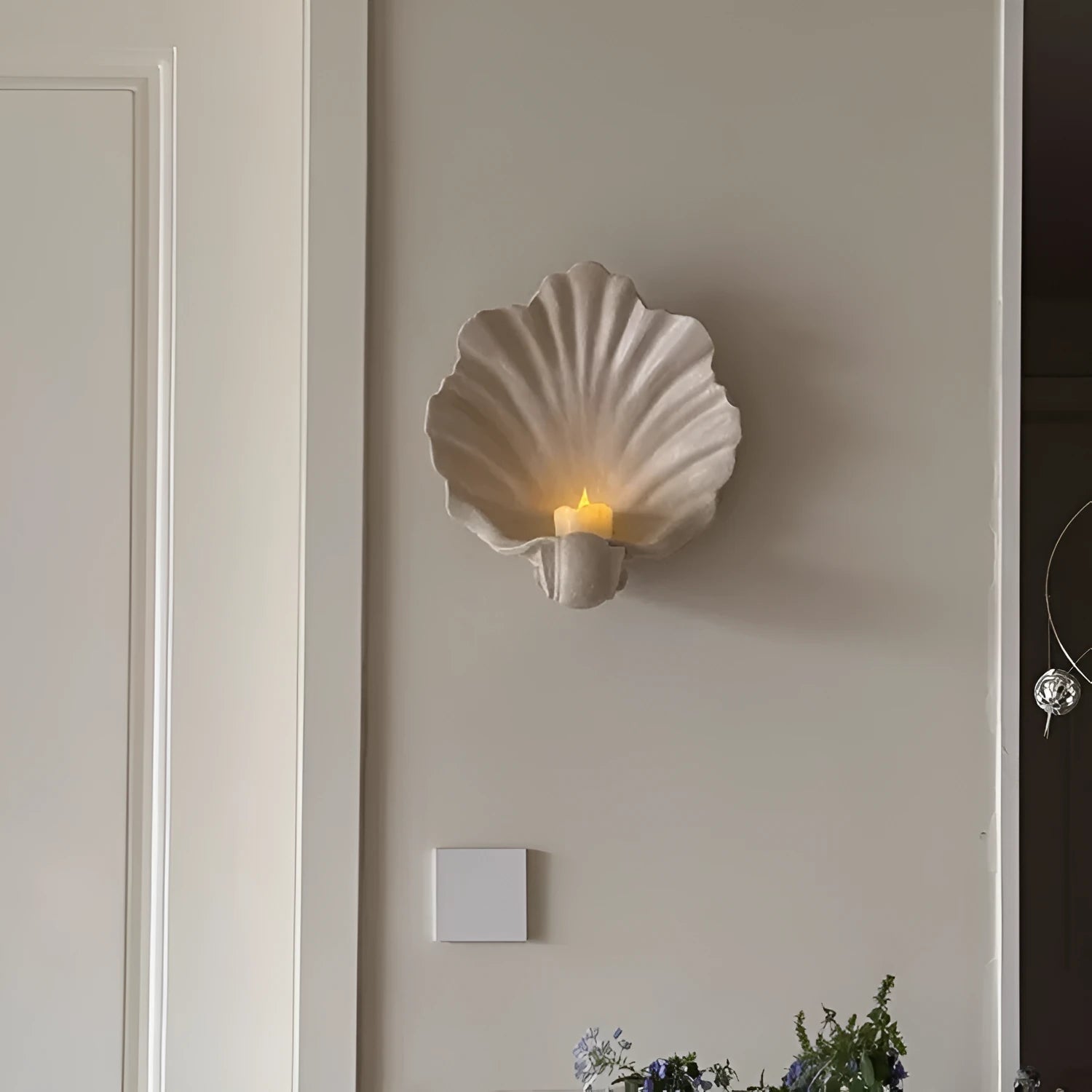 White resin shell-shaped fruit plate ornament on a table.