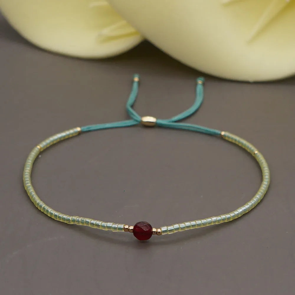 Women's handmade colourful beaded bracelet with geometric glass beads on adjustable cord