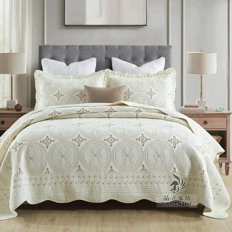Double thick pure cotton European-style embroidered bed cover set with two pillowcases on a bed.