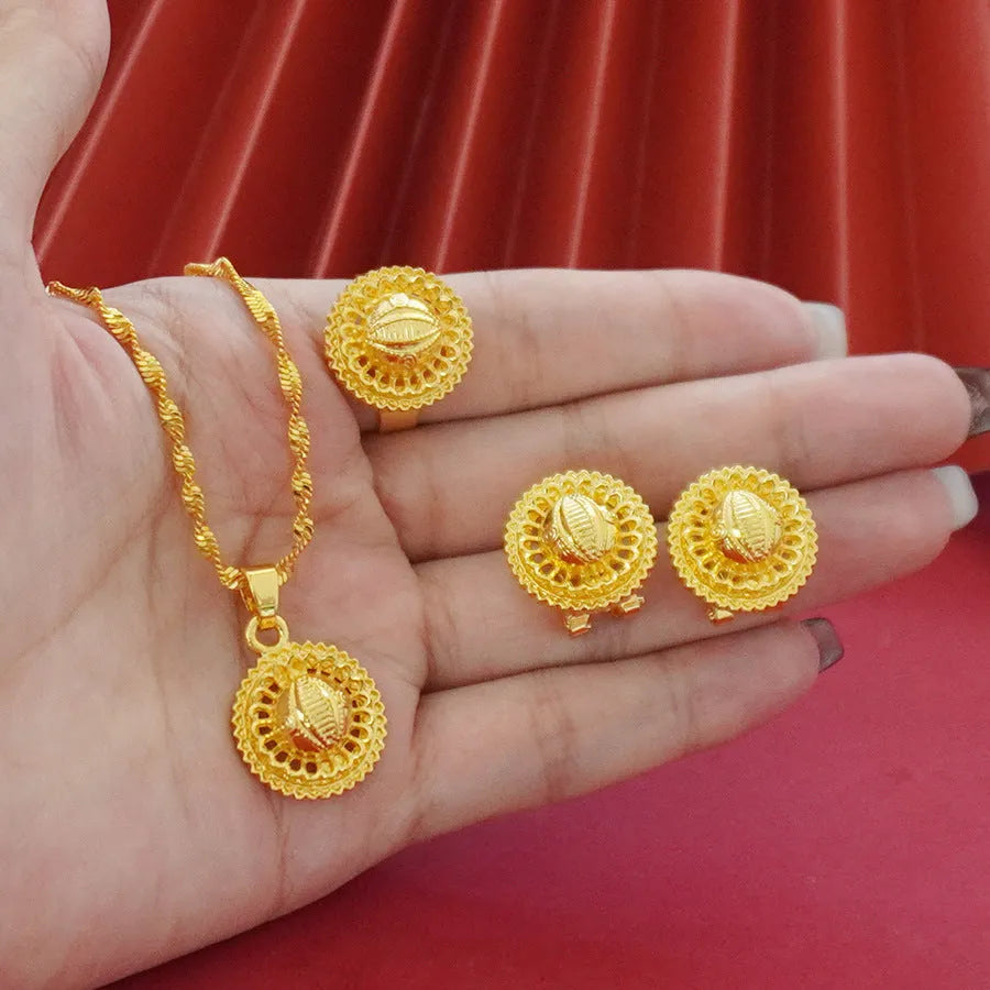 Gold-plated three-piece jewellery suit with landscape Middle East flower designs showing earrings, ring and pendant necklace
