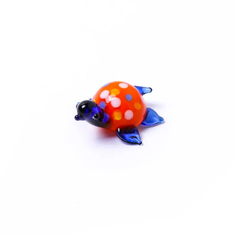 Geometric glass turtle desktop ornament in modern simplicity style on a wooden surface.