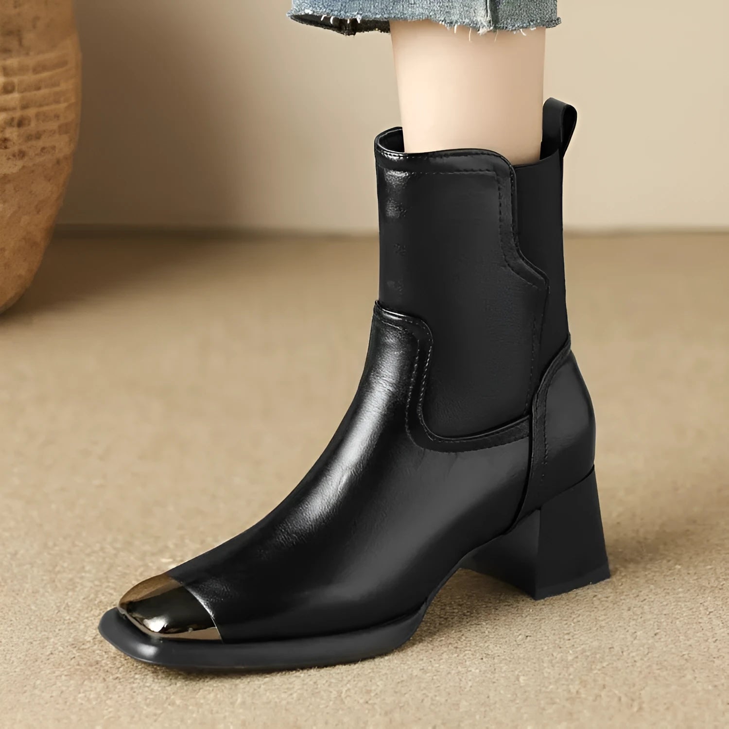 Brown women's Martin boots with side zipper and decorative metal details on a rubber sole.