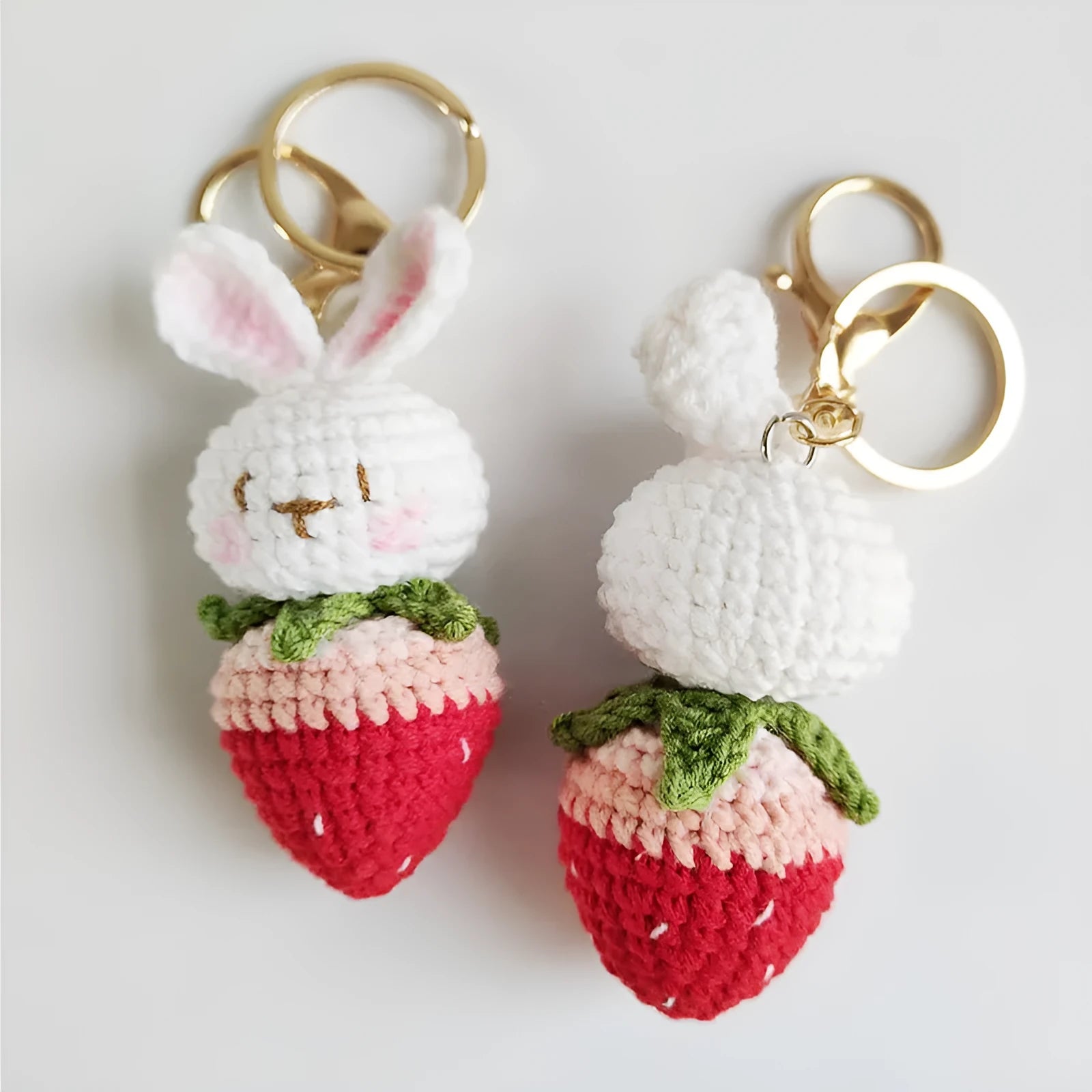 White hand-woven rabbit strawberry pendant on key with cartoon-style wire construction