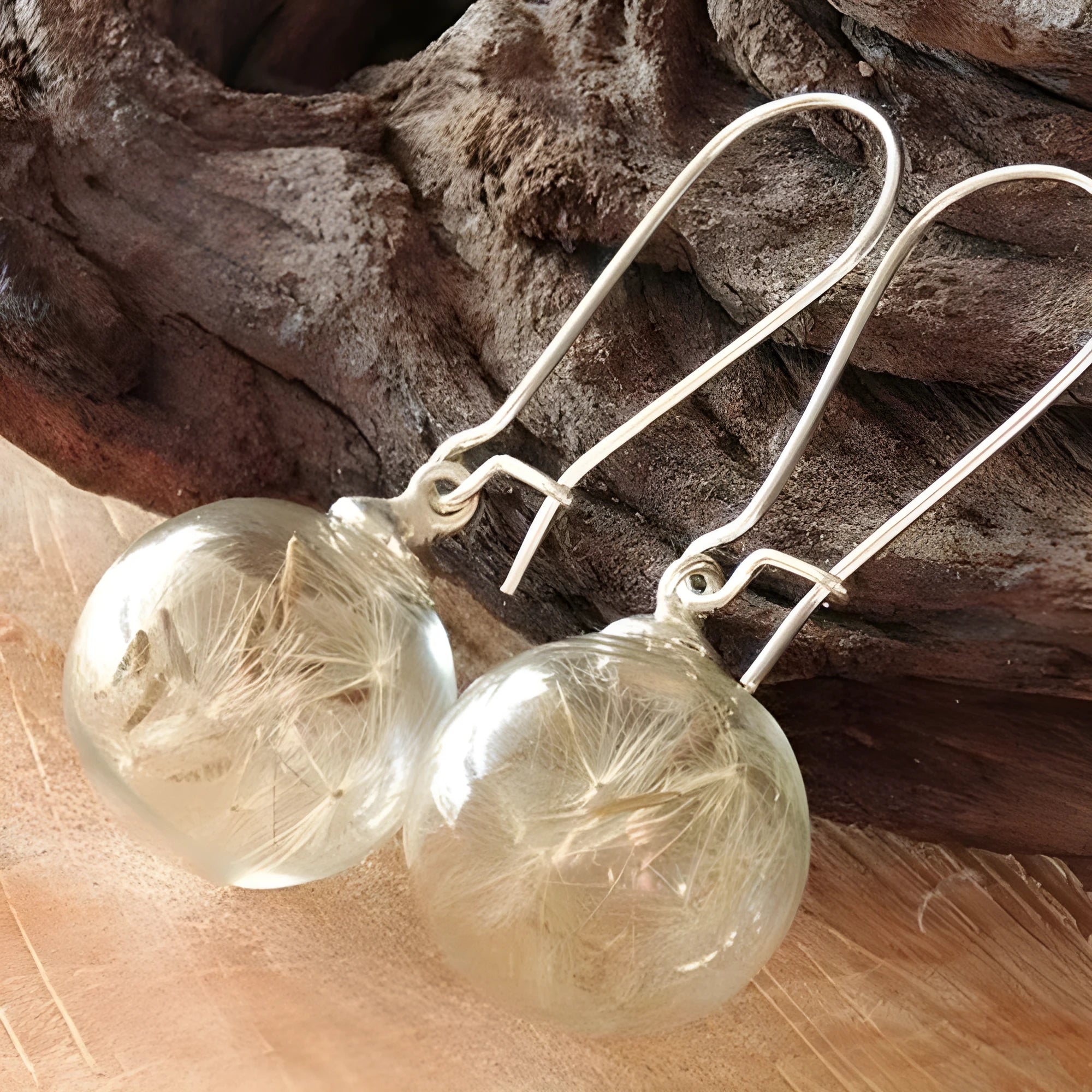 Transparent 16mm glass ball earrings with dandelion seed crystal design on silver French hooks
