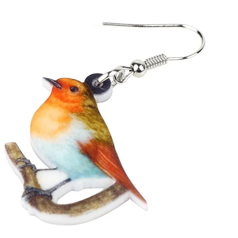 Blue Titmouse bird pendant acrylic earrings with geometric shapes and snake zodiac motifs.