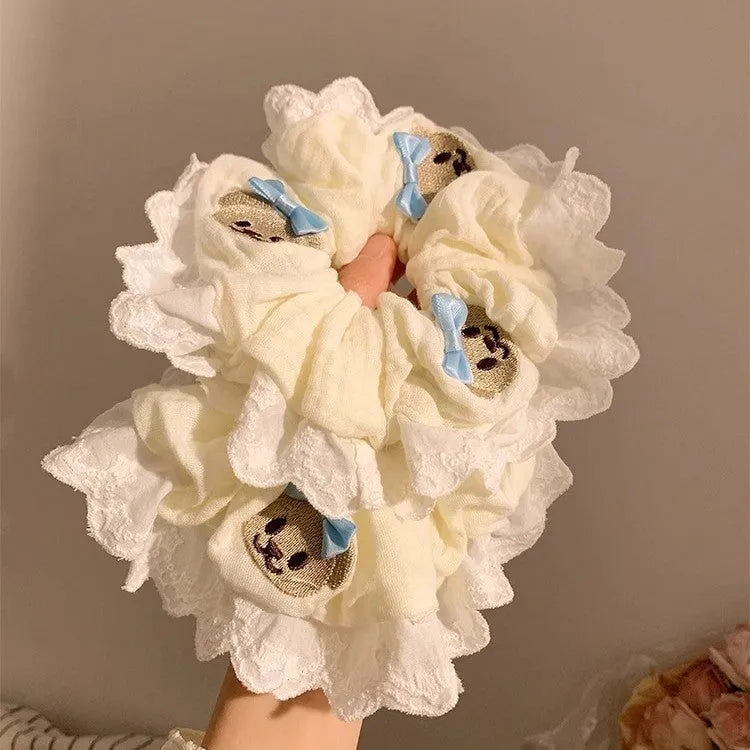 Blue cloth hair ring with bear motif and bow detailing, elastic construction