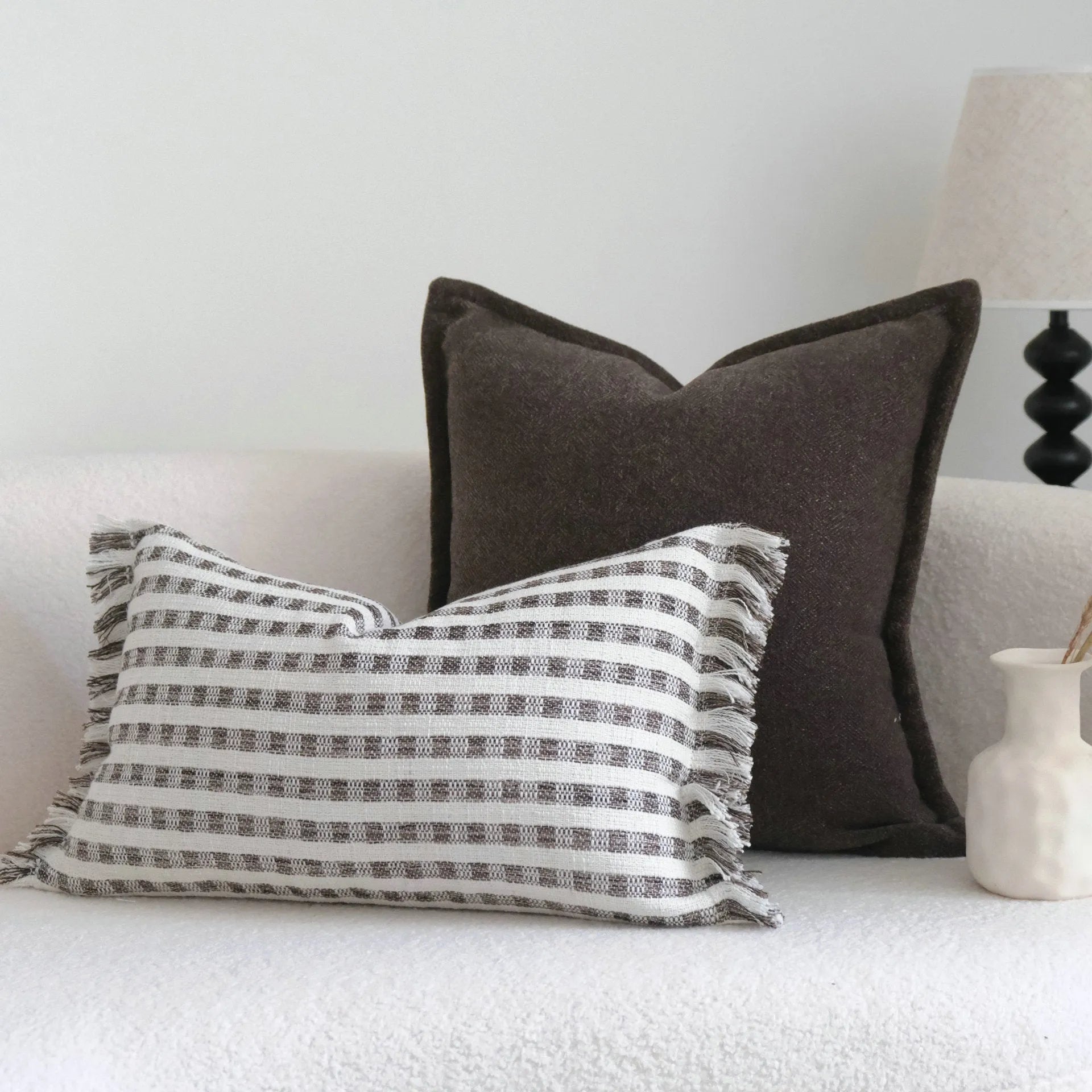 Coffee brown striped Chinese classical style decorative sofa cushion on a grey sofa.