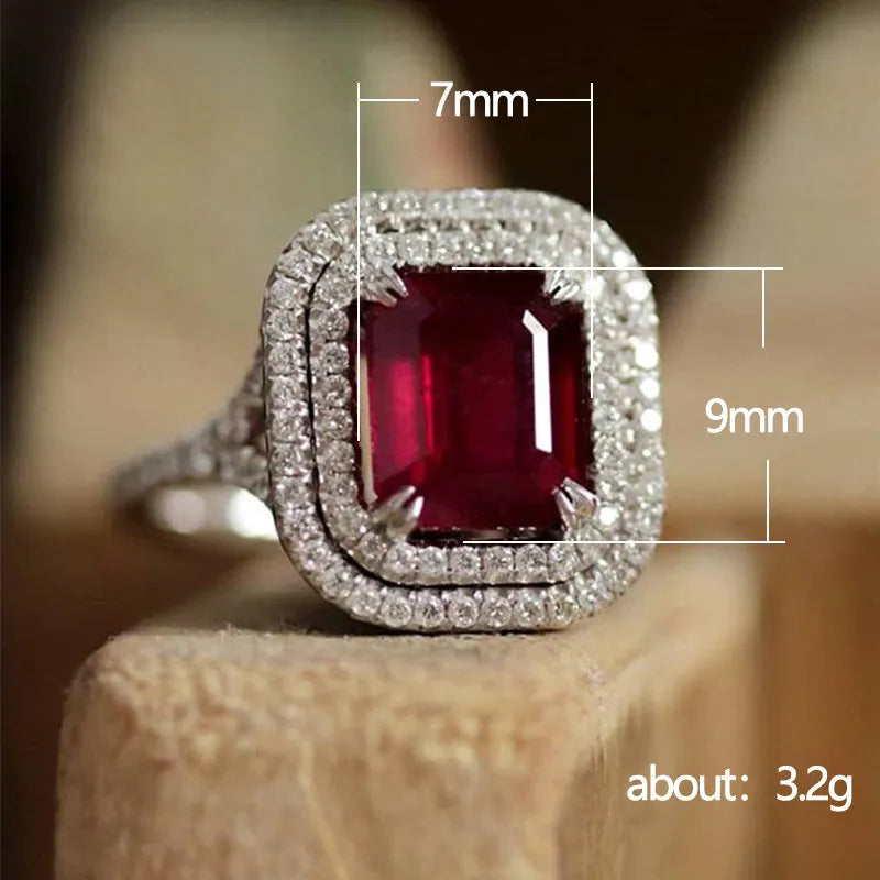 Copper square princess ring with red rhinestones on a geometric band.