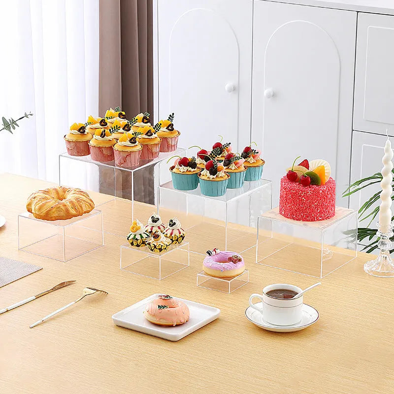 Set of six white geometric plastic cubes arranged as a tiered dessert display stand.
