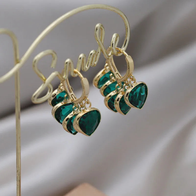 Korean style women's green heart ear clip earrings with alloy inlay gemstone.