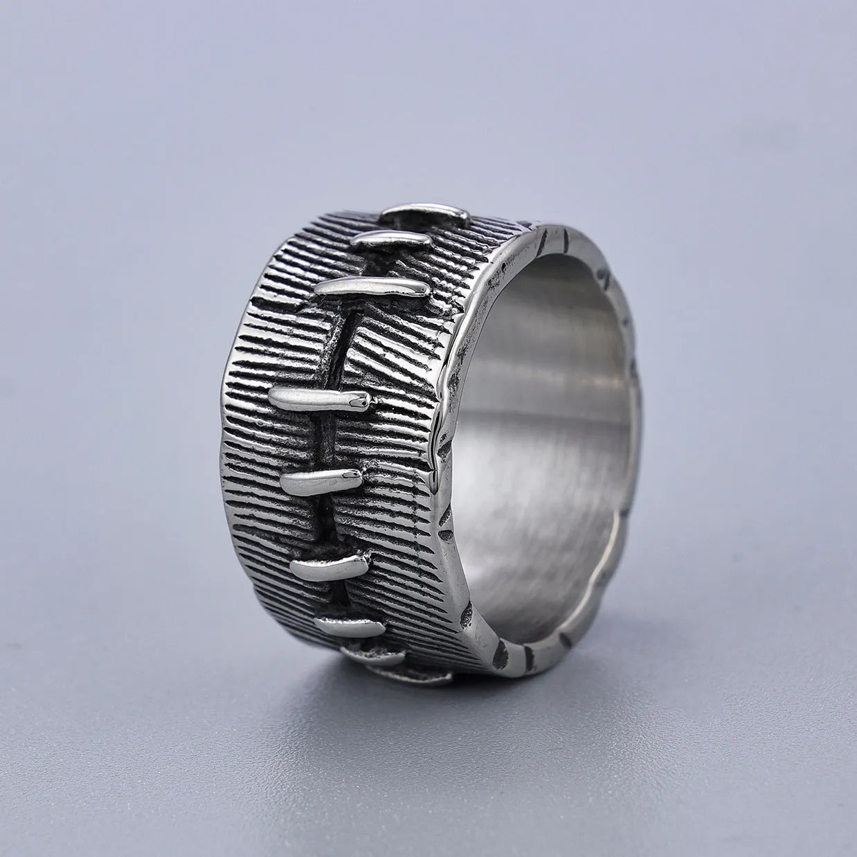 Dark punk geometric ring with double ring design and stitched detailing in retro colour on titanium steel