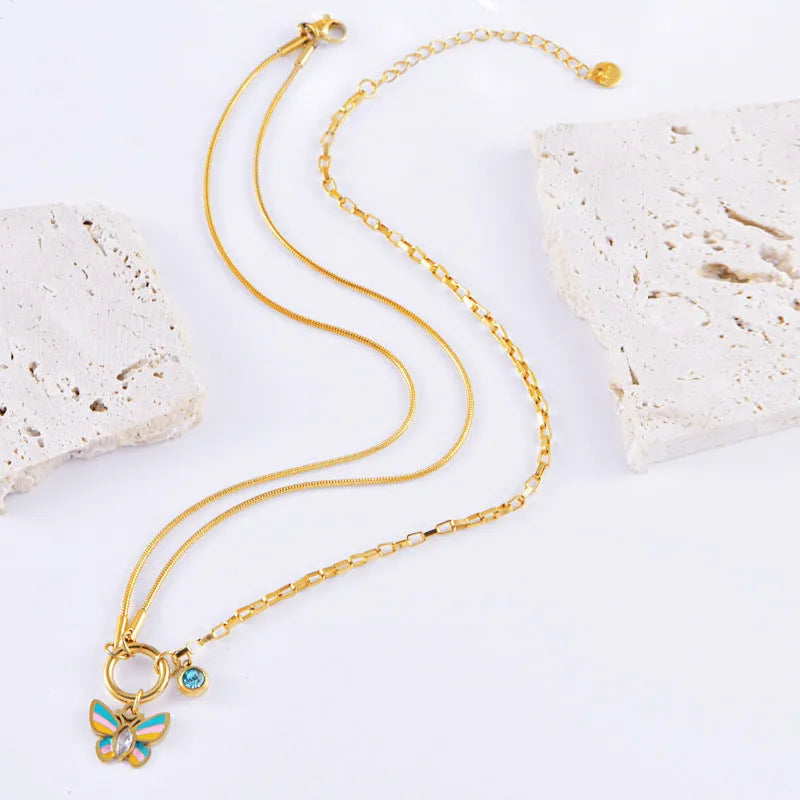 Gold titanium steel butterfly jewellery set with necklace and bracelet on snake bone chains