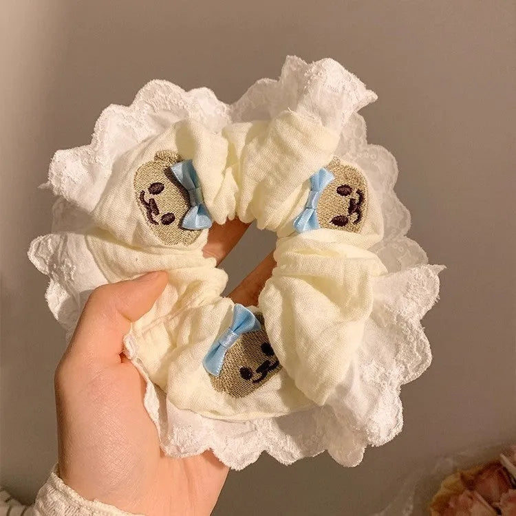 Blue cloth hair ring with bear motif and bow detailing, elastic construction