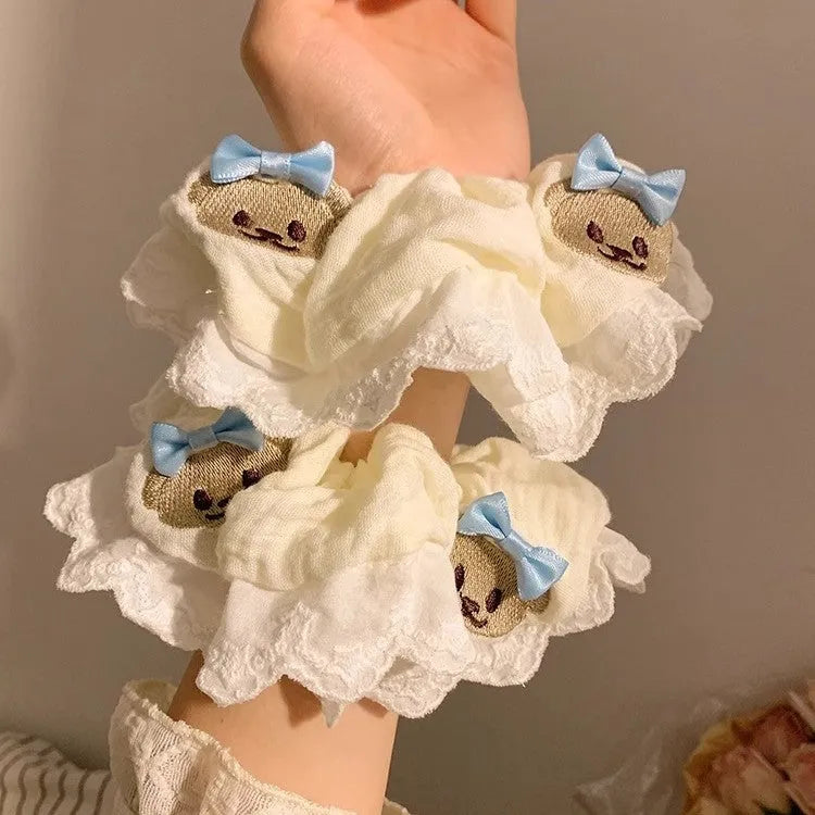 Blue cloth hair ring with bear motif and bow detailing, elastic construction