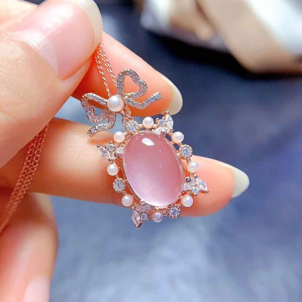 Geometric rose gold plated silver pendant with a natural pink rose quartz crystal on a chain.