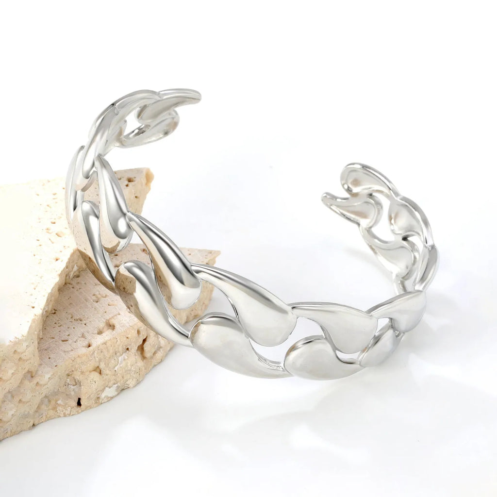 Minimalist stainless steel alloy bracelet in silver, gold, and rose gold colour options on a wrist.