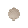 White resin shell-shaped fruit plate ornament on a table.
