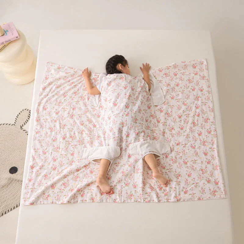 Anti-kick sleeping bag blanket in a summer design on a bed, showing its lightweight texture.