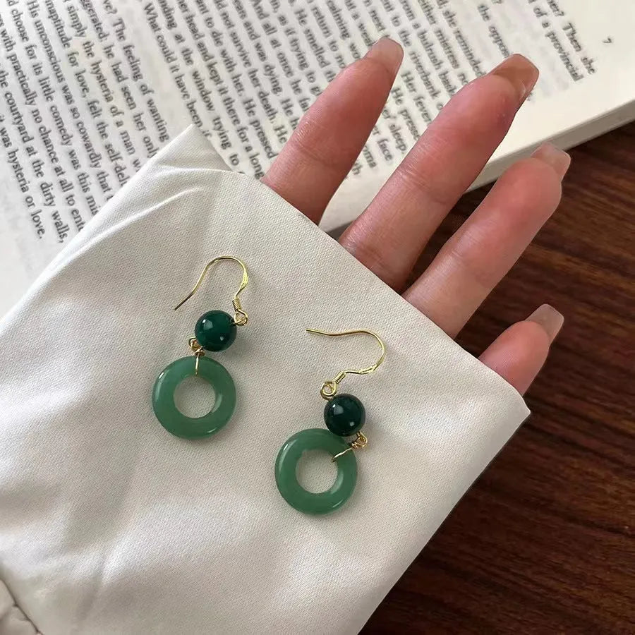 Green jade design peace buckle earrings with 14K gold plating on zinc alloy