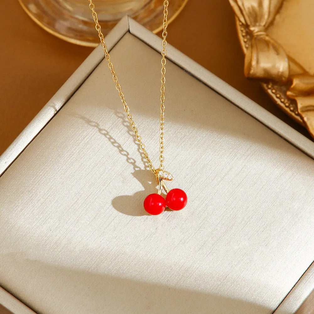 Women's titanium steel necklace with O-ring chain showing cherry, strawberry, and pepper charm options.