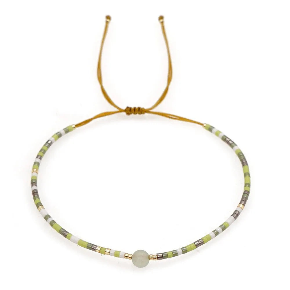 Women's handmade colourful beaded bracelet with geometric glass beads on adjustable cord