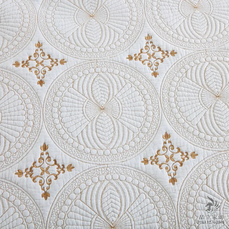 Double thick pure cotton European-style embroidered bed cover set with two pillowcases on a bed.