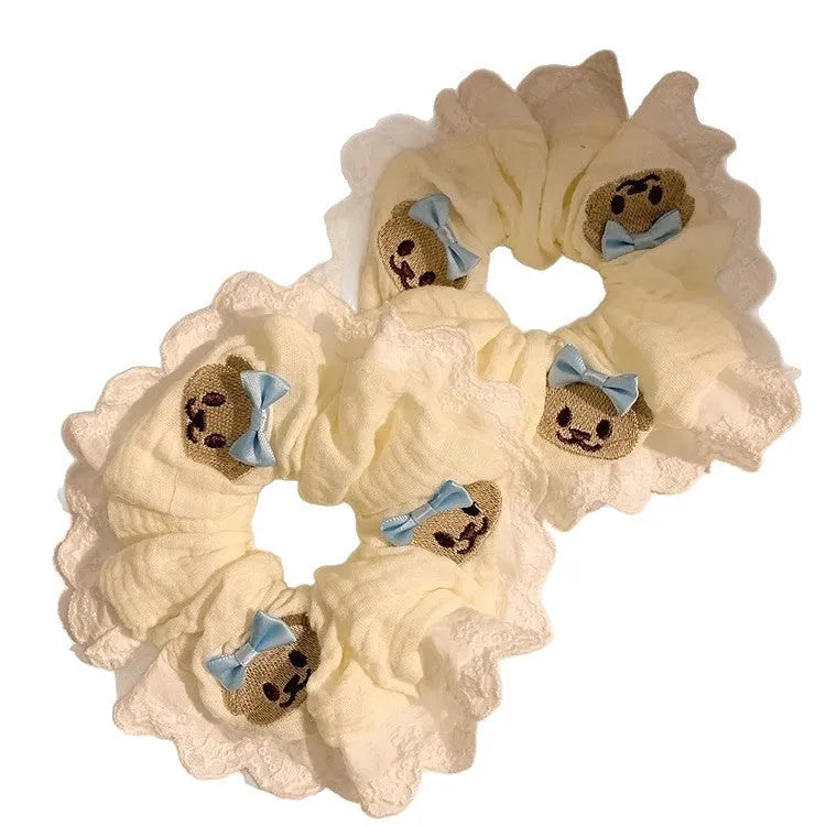 Blue cloth hair ring with bear motif and bow detailing, elastic construction