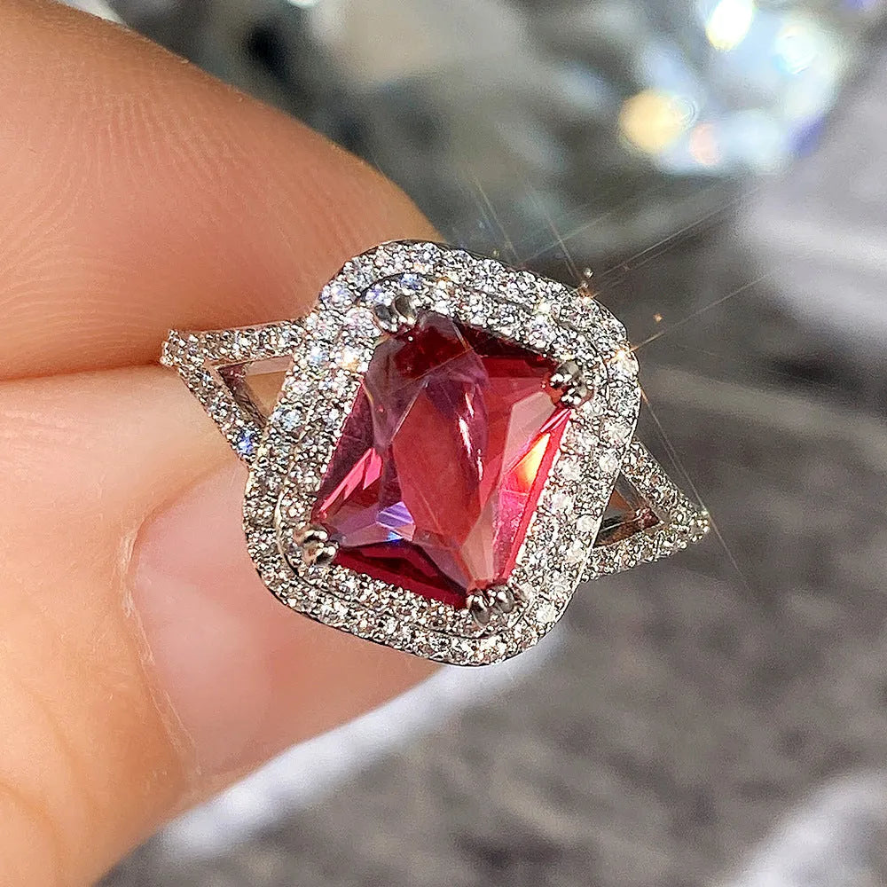 Copper square princess ring with red rhinestones on a geometric band.