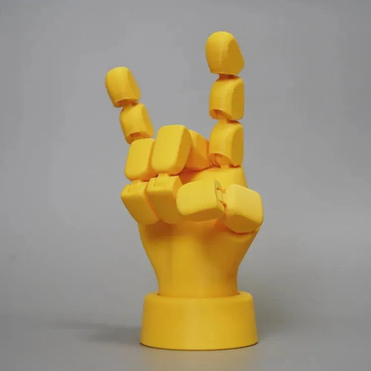 Yellow hand ornaments figurine with movable joints measuring 5 by 5.38 by 7.5 centimetres