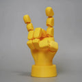Yellow hand ornaments figurine with movable joints measuring 5 by 5.38 by 7.5 centimetres