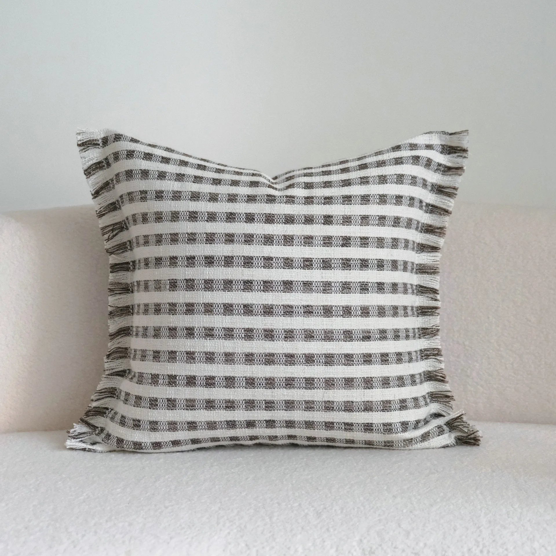 Coffee brown striped Chinese classical style decorative sofa cushion on a grey sofa.