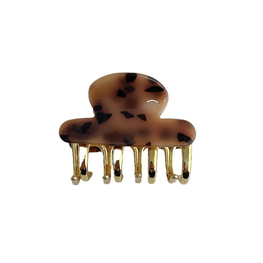 Set of four retro acetate hair barrettes with metal grip in beige, white, dark, and leopard print designs