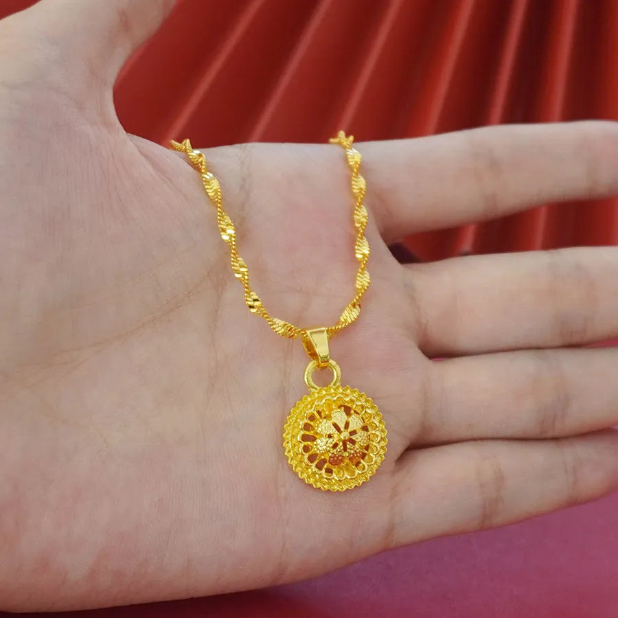 Gold-plated three-piece jewellery suit with landscape Middle East flower designs showing earrings, ring and pendant necklace