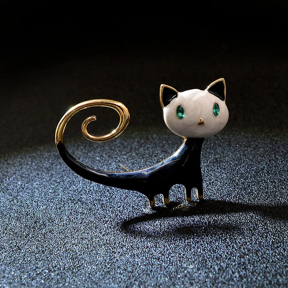 Close-up of a white painted cat tail brooch made from alloy metal.