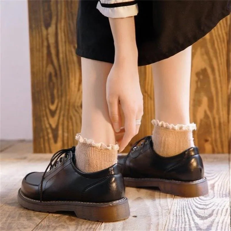 Black retro women's Mary Jane shoes with front lace-up and low square heel.