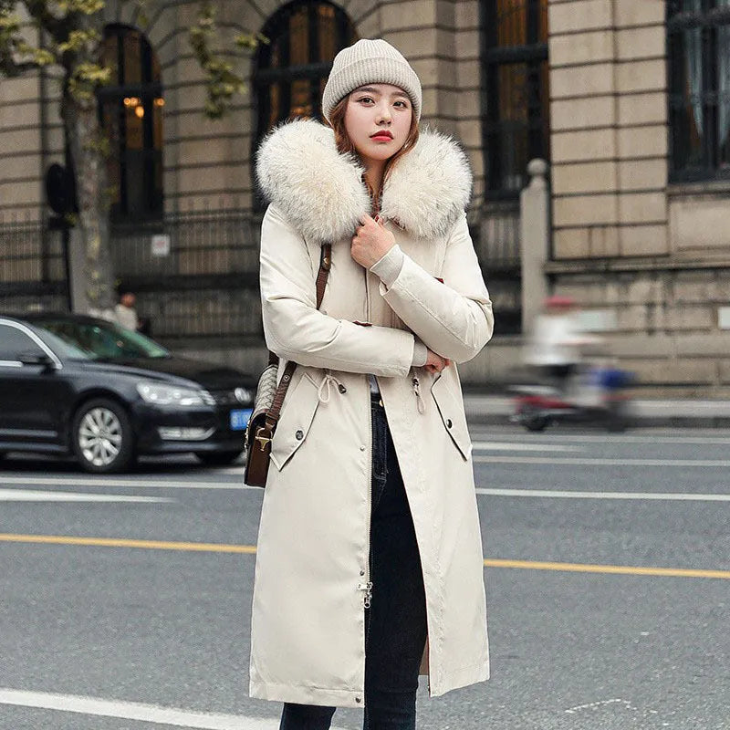 Women's long beige fleece trench coat with a belt, shown on a model.