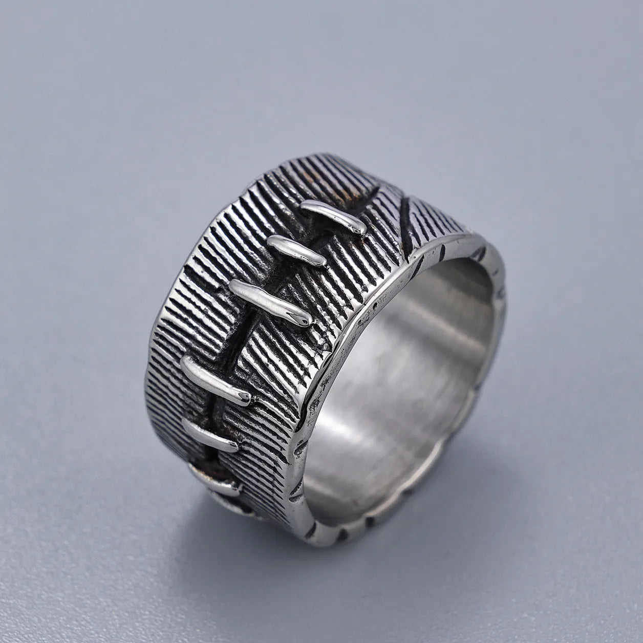 Dark punk geometric ring with double ring design and stitched detailing in retro colour on titanium steel