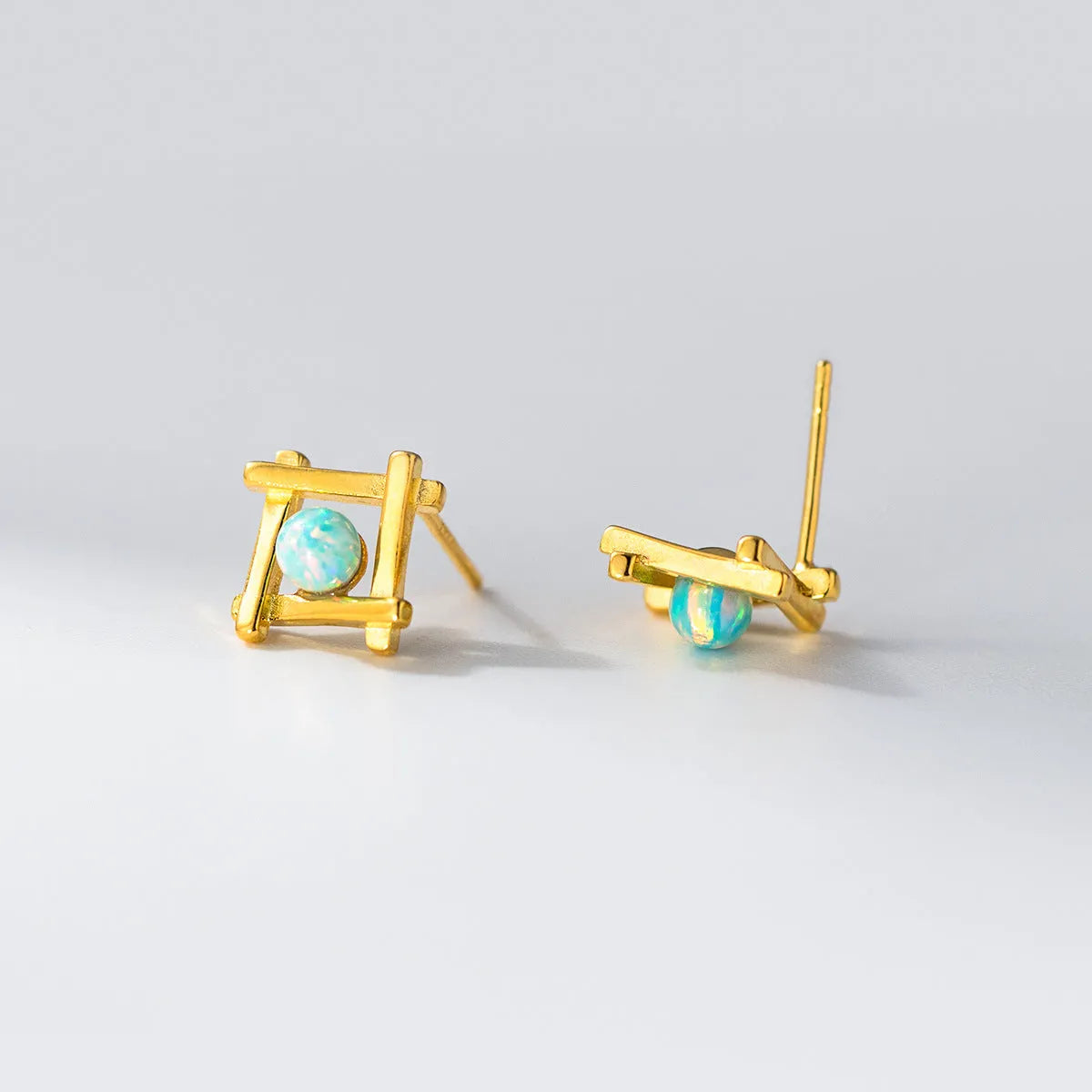 Geometric cross stud earrings in sterling silver with gold or silver plating options