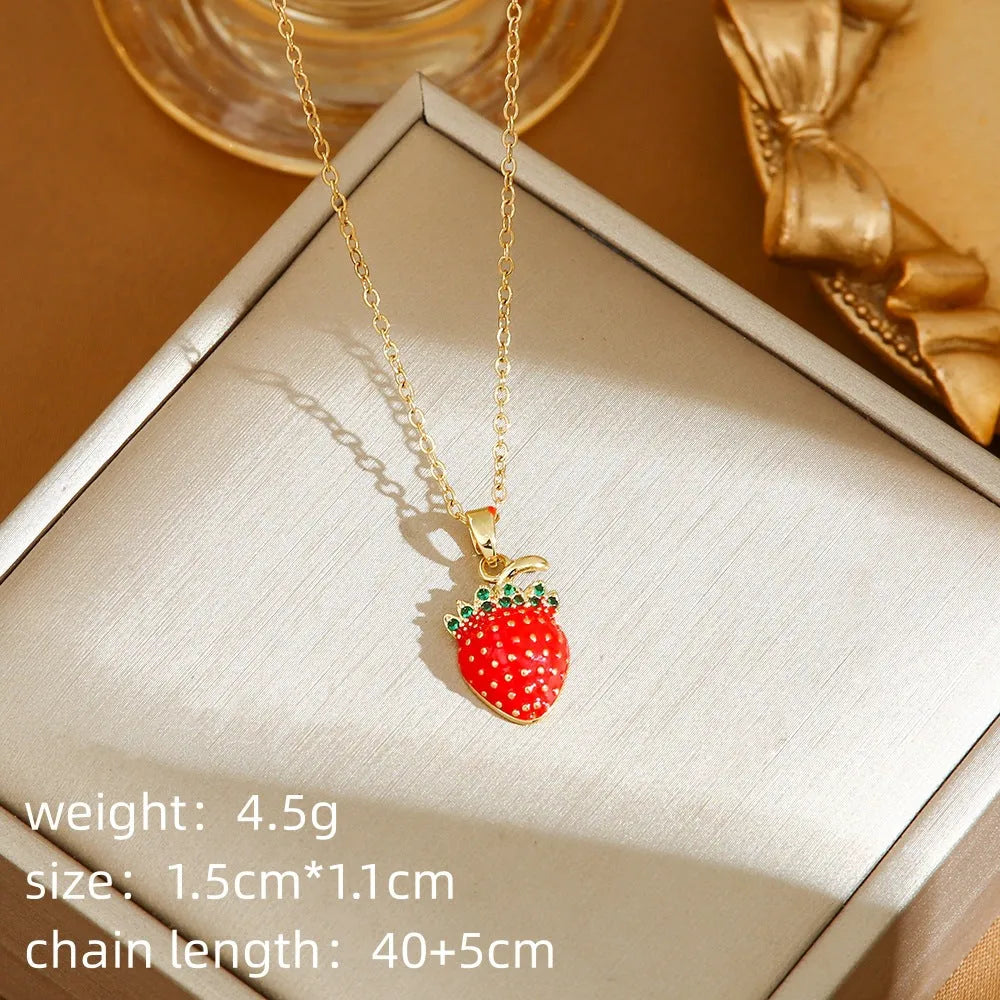 Women's titanium steel necklace with O-ring chain showing cherry, strawberry, and pepper charm options.