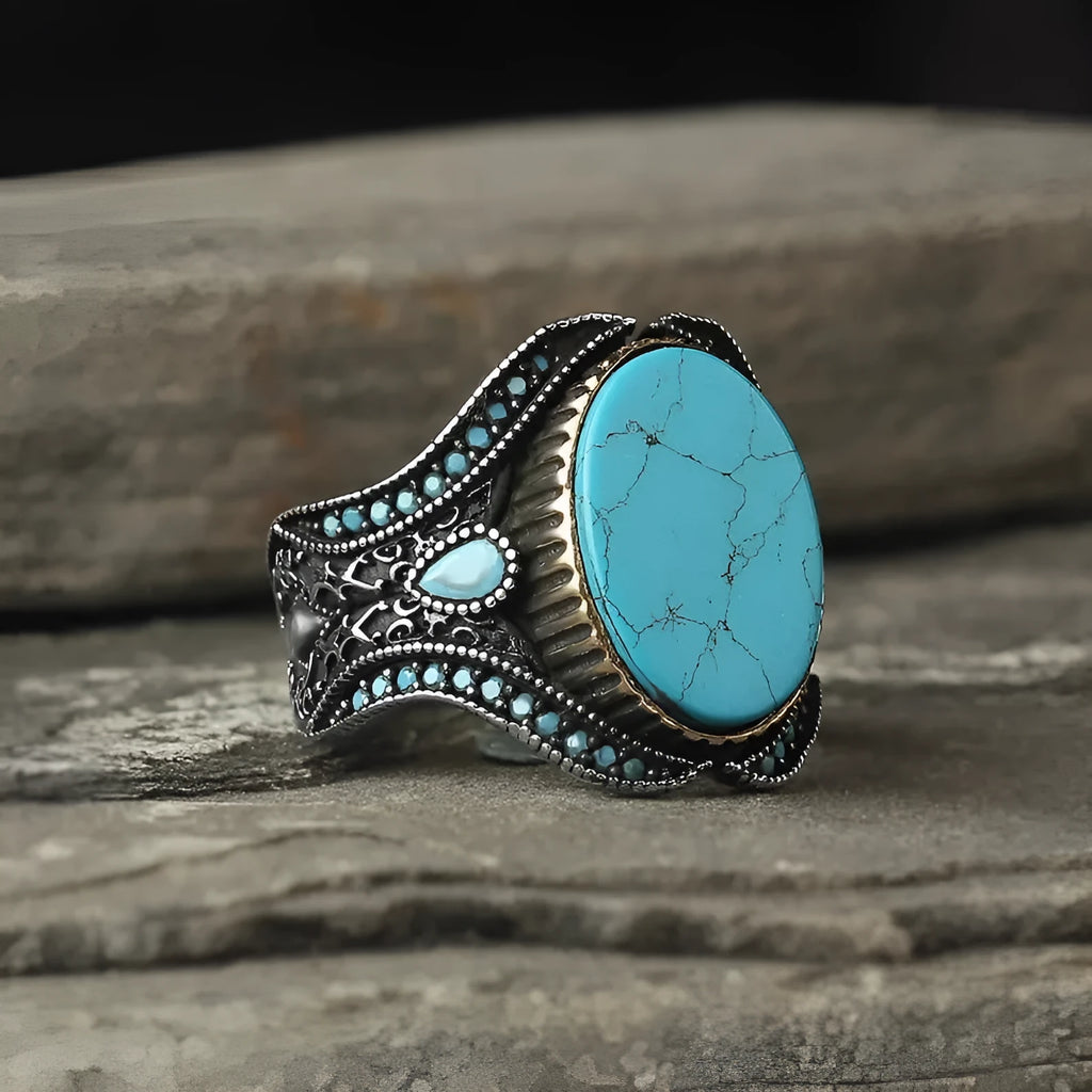 Men's round turquoise ring with antique silver finish showing circular alloy band design