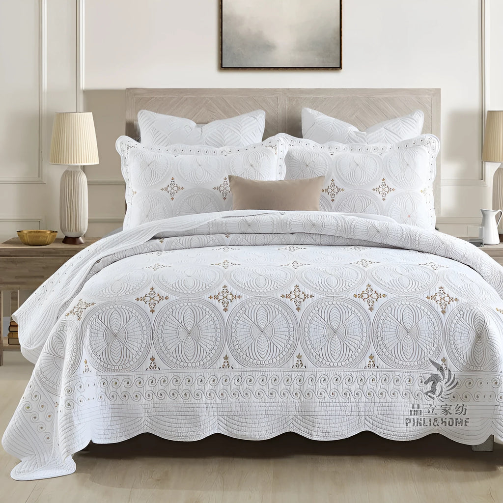 Double thick pure cotton European-style embroidered bed cover set with two pillowcases on a bed.