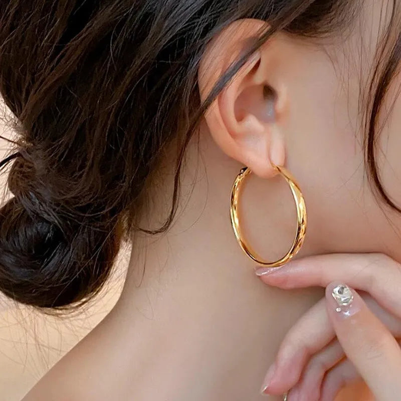 40mm diameter gold and silver metal circle earrings on display