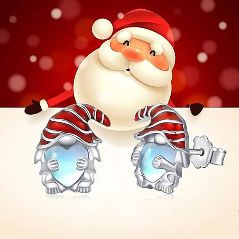 Close-up of women's heart-shaped earrings with a Santa Claus design in a white gold colour.