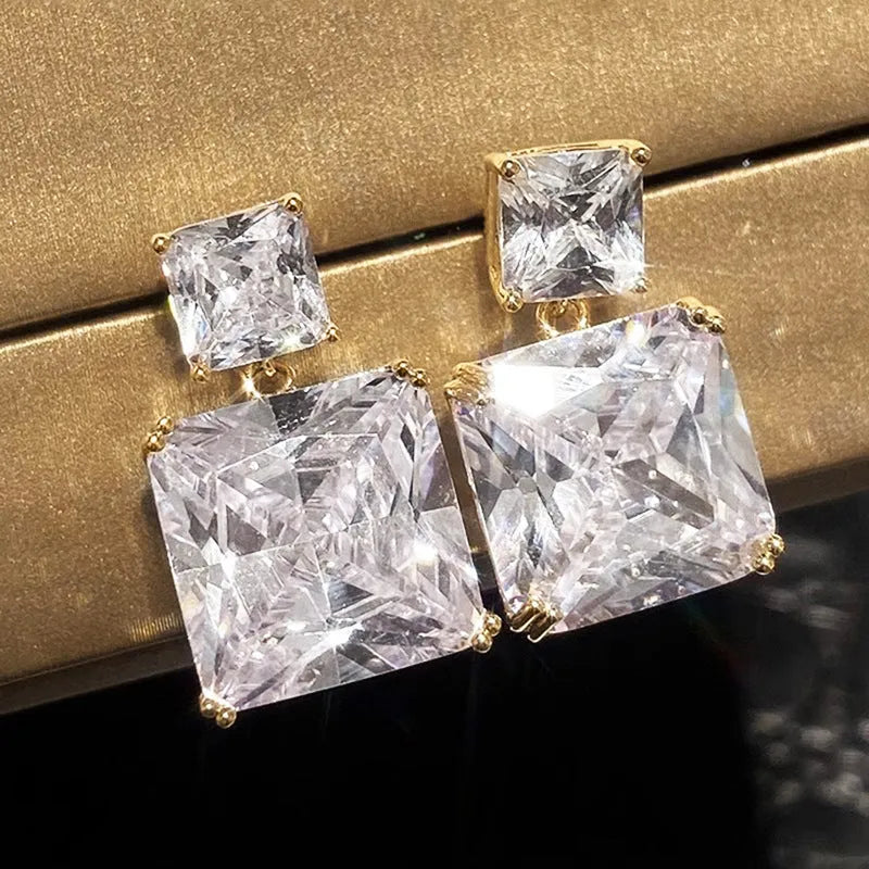 A pair of geometric square design earrings for women in a gold colour finish, made from copper.