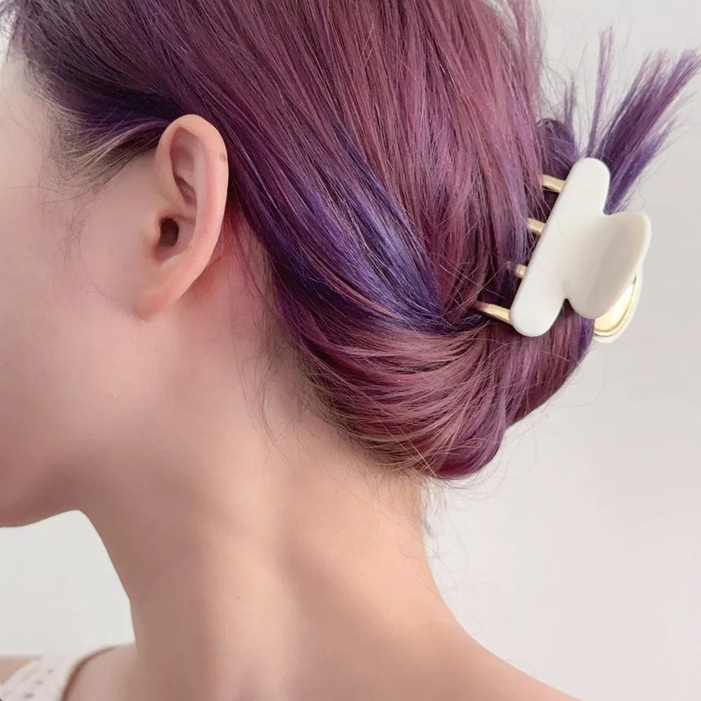 Set of four retro acetate hair barrettes with metal grip in beige, white, dark, and leopard print designs